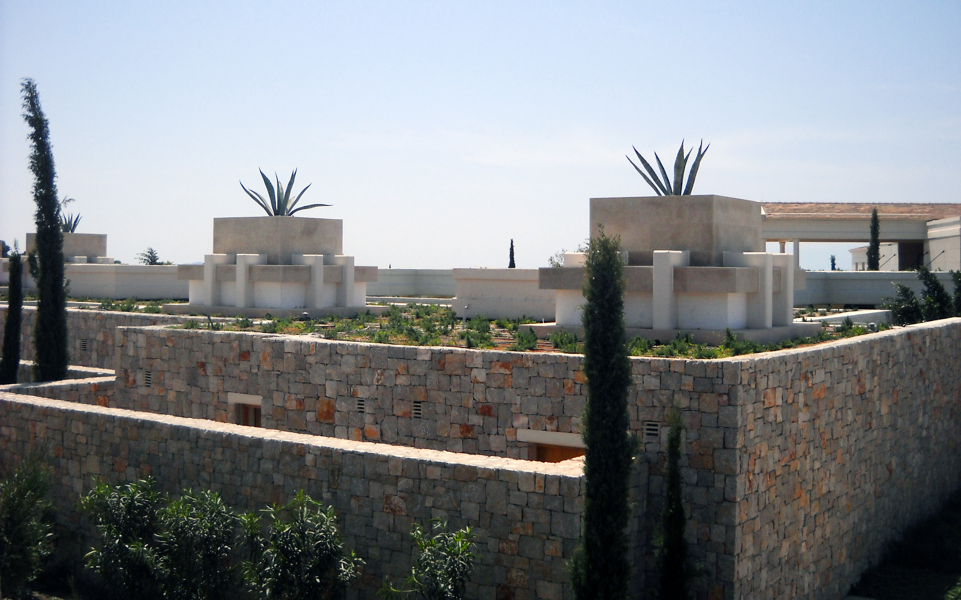 Stone houses with green roofs and Agaves